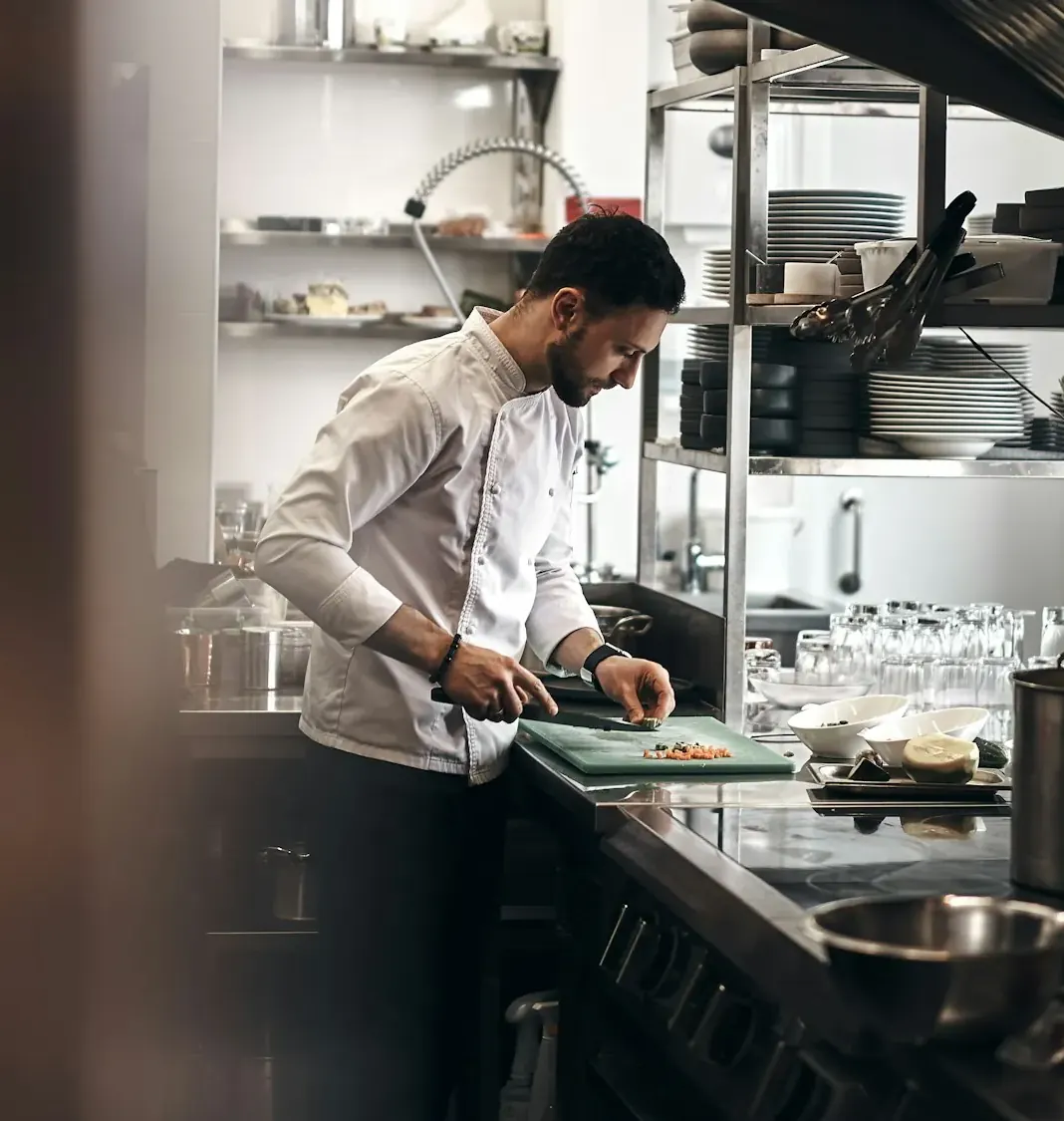 Chef working in a stainless commercial kitchen