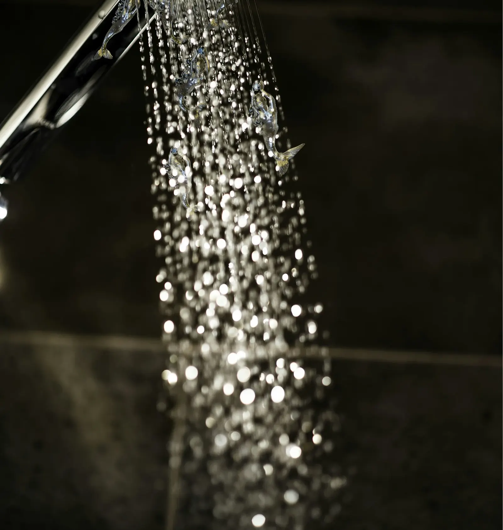 Shower spray falling against a dark wall