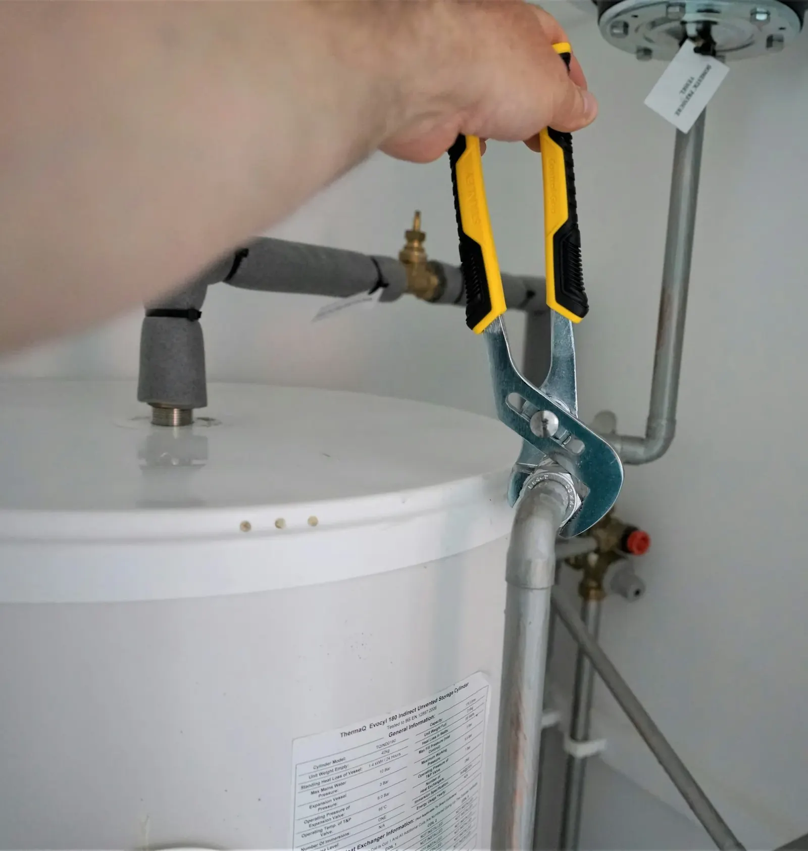 Water heater with copper fittings and a technician's wrench