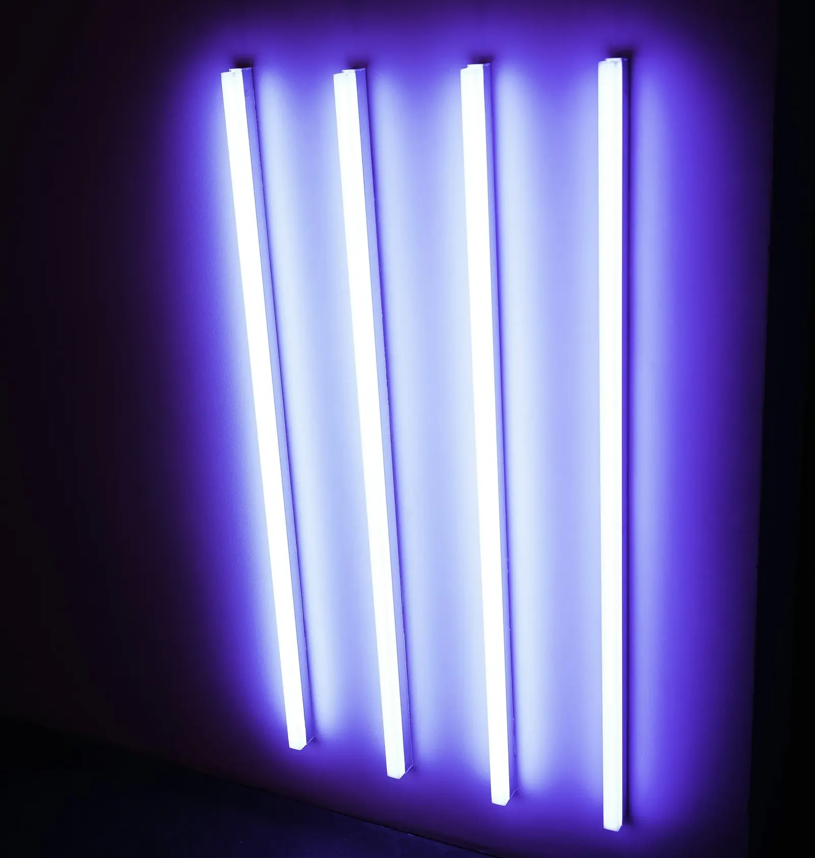 Glowing violet ultraviolet tubes against a dark background